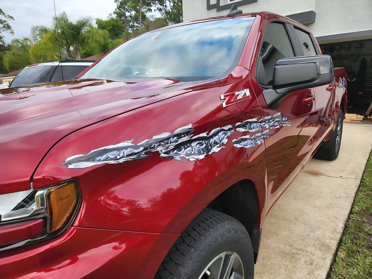 Dragons tear vinyl graphics on red truck